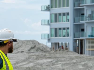 Beach renourishment crew standing in front of the Ocean Club building