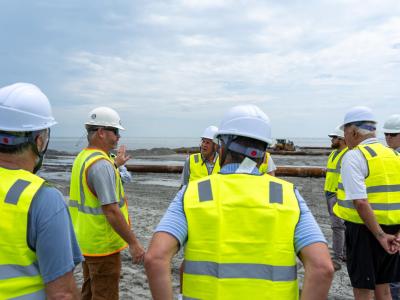 Residents, staff, and committee members meeting on the beach